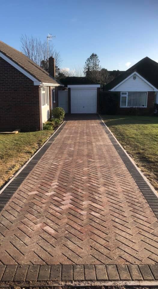 Modern block paved driveway leading to a house entrance